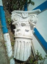 Capital, crowning part of an ancient antique column or pilaster, lying on the street as an element of street decor Royalty Free Stock Photo