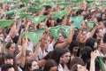 A crowd of women raises green handkerchiefs, symbol of fight for legal abortion