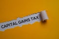 Capital Gains Tax Text written in torn paper