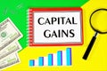 Capital gains-writing text on a Notepad. Money to Finance a business, Royalty Free Stock Photo