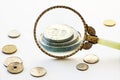 Capital increase, magnifying glass enlarge a few coins, bright g Royalty Free Stock Photo
