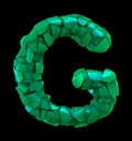 Capital letter G made of broken plastic green color isolated on black background