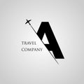 Capital A letter is inserted in the paper slot with the plane slice letter A for travel logo