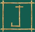 Capital letter J made of realistic brown dry bamboo poles inside of wooden stick frame Royalty Free Stock Photo