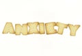 Capital letter shaped biscuits forming word ANXIETY isolated on white background Royalty Free Stock Photo