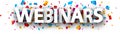 Capital letters webinars paper sign over confetti background Royalty Free Stock Photo