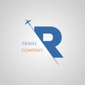 Capital R letter is inserted in the paper slot with the plane slice letter R for travel logo