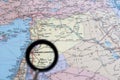 The capital of Syria, Damascus, through a magnifying glass on the background of a geographical map. Background Royalty Free Stock Photo