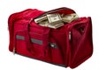 Capitalism, money stash and loot in handbag conceptual idea with duffle bag made of red material full of banknote heap isoalted on