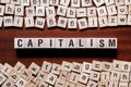 Capitalism word concept on cubes