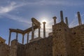 Capitals, cornice and columns of the Roman theater of Merida, with the sun backlighting at sunset creating a divine flash of a