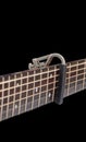 Capo on the Acoustic guitar neck , capro made from aluminium, Selective focus at capo Royalty Free Stock Photo