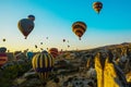 Cappadocia, Goreme, Anatolia, Turkey: Scenic vibrant view of balloons flight in Cappadocia valley in sunrise rays. Royalty Free Stock Photo