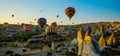 Cappadocia, Goreme, Anatolia, Turkey: Scenic vibrant view of balloons flight in Cappadocia valley in sunrise rays Royalty Free Stock Photo