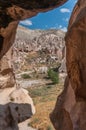 Cappadocia from inside cave house. Impressive fairy chimneys of sandstone in the canyon near Cavusin village, Cappadocia, Nevsehir