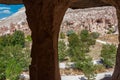 Cappadocia from inside cave house. Impressive fairy chimneys of sandstone in the canyon near Cavusin village, Cappadocia, Nevsehir