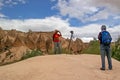 Cappadocia, Turkey - April 29, 2014: Stone columns Red Valley. Tourists are photographed on a background of geological formations Royalty Free Stock Photo