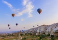 Cappadocia, Turkey - August 31, 2011: Hot air balloon flying over rocky landscape at sunrise in Cappadocia Royalty Free Stock Photo