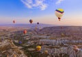 Cappadocia, Turkey - August 31, 2011: Hot air balloon flying over rocky landscape at sunrise in Cappadocia Royalty Free Stock Photo