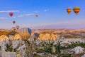 Cappadocia, Turkey - August 31, 2011: Hot air balloon flying over rocky landscape at sunrise in Cappadocia Royalty Free Stock Photo