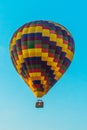 Cappadocia, Turkey: Colorful balloon on blue sky background. Parallel movement of air and road transport
