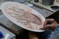 Artist paints unfired pottery in Avanos