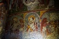 Cappadocia, Turkey - September 13, 2021: Early Christian mural. Saints, defaced gouged eyes, in rock carved Saint Barbara Church. Royalty Free Stock Photo