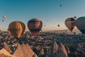 Cappadocia / Turkey - September 14, 2020: Flying hot air balloons and rock landscape at sunrise time in Goreme, Cappadocia, Turkey