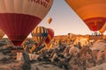Cappadocia / Turkey - September 14, 2020: Flying hot air balloons and rock landscape at sunrise time in Goreme, Cappadocia, Turkey
