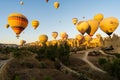 Cappadocia, Turkey - September 14, 2021: Panoramic view of bunch of colorful hot air balloons taking flight or flying int he sky