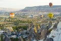 10.11.2022 Cappadocia, Turkey. Several hot air balloons in vivid colors flying over peaceful Turkish city of Cappadocia