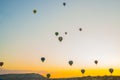 Cappadocia, Turkey: The silhouettes of the balloons early in the morning on a background of yellow-orange sky