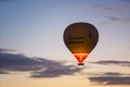 10.11.2022 Cappadocia, Turkey Single hot air ballon slowly flying in the air. Tourists viewing amazing sunrise on