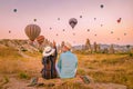 Cappadocia Turkey during sunrise, couple mid age men and woman on vacation in the hills of Goreme Capadocia Turkey, men Royalty Free Stock Photo