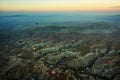 Cappadocia, Turkey: Top view early in the morning from the balloon, misty landscape with fog with mountains and colorful balloons