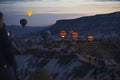 10.11.2022 Cappadocia, Turkey. Tourism concept. Nature and humans. People watching the take-off of beautifully colored