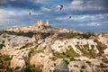 Cappadocia Uchisar castle and hot air balloons Royalty Free Stock Photo