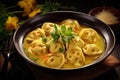 cappelletti in brodo. Traditional italian soup on wooden table