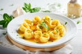 cappelletti in brodo. Traditional italian soup on wooden table