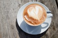 Cappucchino on a wooden table in the sun Royalty Free Stock Photo