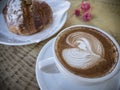 Cappuccino and brioche in cafe. Royalty Free Stock Photo