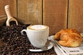 Cappuccino, brioches and newspaper with background