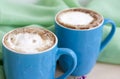 Cappuccino coffee in beautiful blue cups. Spring mood with a Cup of coffee. Royalty Free Stock Photo