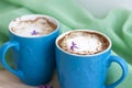 Cappuccino coffee in beautiful blue cups. Spring mood with a Cup of coffee. Royalty Free Stock Photo