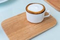 Cappuccino coffee cup on wooden plate
