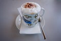 Cappuccino coffee in porcelain cup with instructions of knot bin