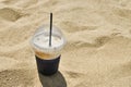 cappuccino coffee with straw on the beach Royalty Free Stock Photo