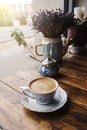Cappuccino coffee, in vintage porcelain cup, on the wooden table