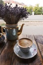 Cappuccino coffee, in vintage porcelain cup, on the wooden table