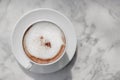 cappuccino coffee in white coffee cup on a marble background table top view Royalty Free Stock Photo